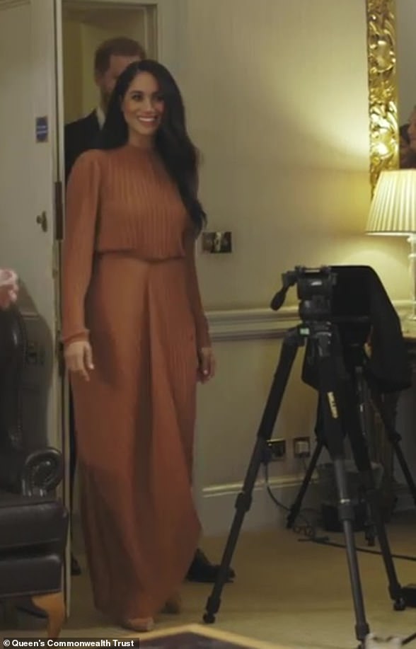 The Duchess of Sussex donned a Preen by Thornton Bregazzi asymmetrical toffee midi dress which cost £925 for a meeting with young leaders for QCT