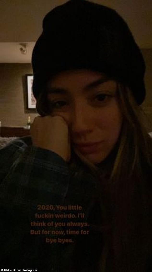 Pushing through: Additionally, the beauty also shared a snap of herself wearing a beanie and looking tired as she pressed one hand on her cheek and called 2020 a 'little f**kin weirdo'