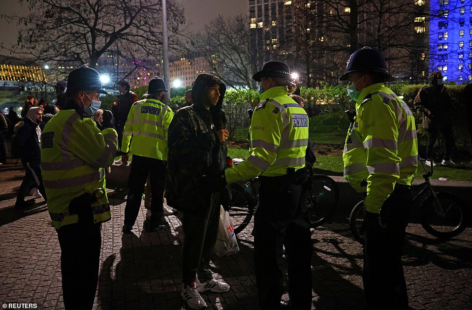 Police officers were seen speaking to a man during an anti-lockdown protest demonstration in London on New Year's Eve