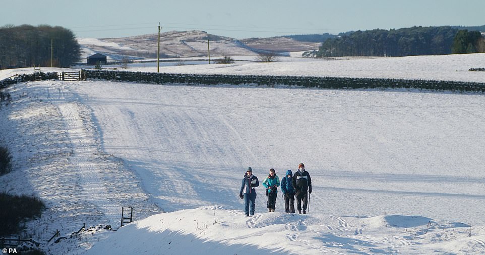 Hikers make their way across a field at Limestone Corner near Hexham, Northumberland, this morning