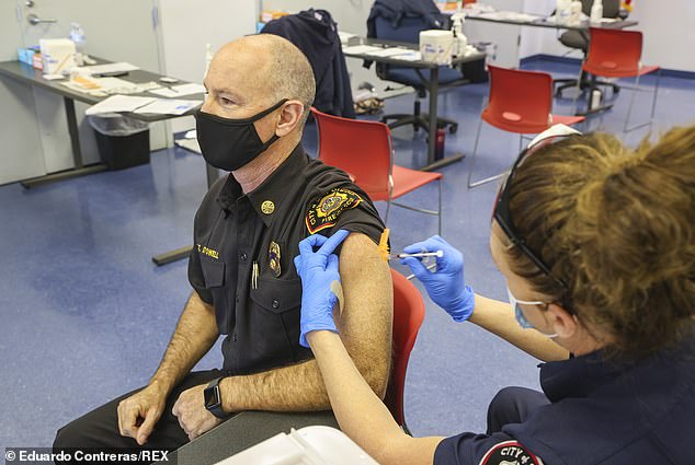 Fire Chief Colin Stowell (left) receives the Pfizer COVID-19 vaccine at the San Diego Fire-Rescue Training Facility on Thursday