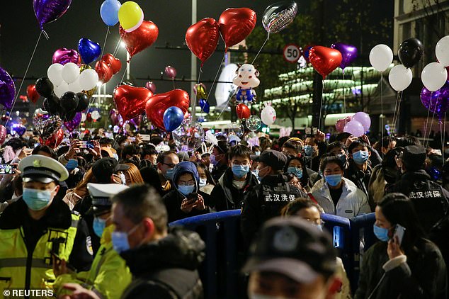 Partygoers, mostly wearing protective face masks, gathered in the streets of Wuhan to welcome 2021