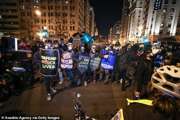 Antifa supporters with shields and umbrellas are seen after the "Million MAGA March" on December 12. Fears are rising of violence as Trump supporters rally on January 6