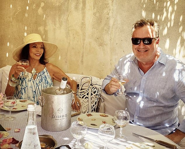 Friends: Piers Morgan enjoys a socially distanced lunch with Dame Joan Collins at their favourite restaurant, Club 55, on Pampelonne beach in St Tropez in July this year