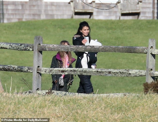 Hilaria carried the couple's youngest child, three-month-old Eduardo 'Edu' Pao Lucas, in a sling as she left their home in Amagansett for the woodland walk