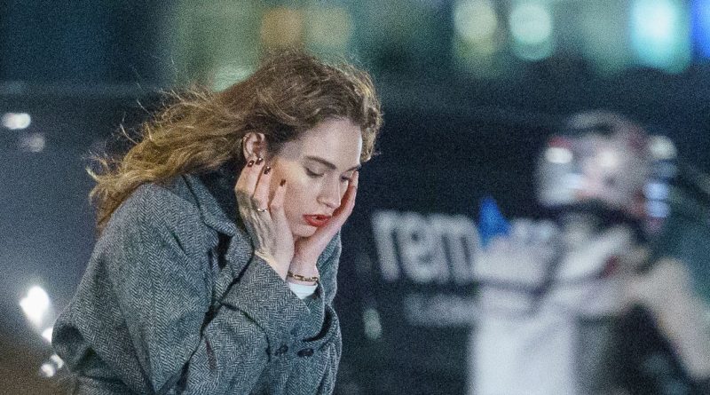 Lily James looks miserable as she gets back to work filming in freezing London