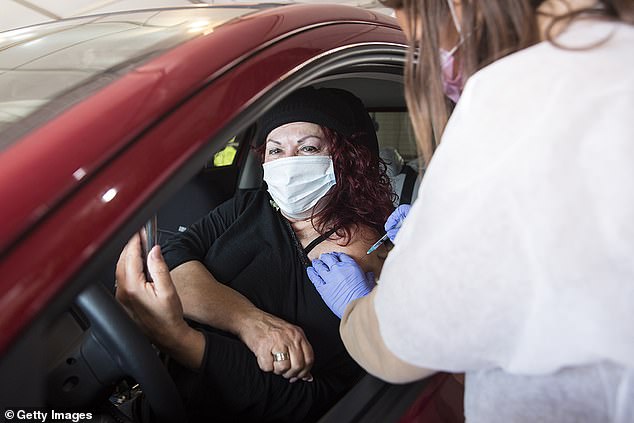 Israelis receive the coronavirus vaccine at a drive in Covid-19 vaccination centre on December 31 in Haifa