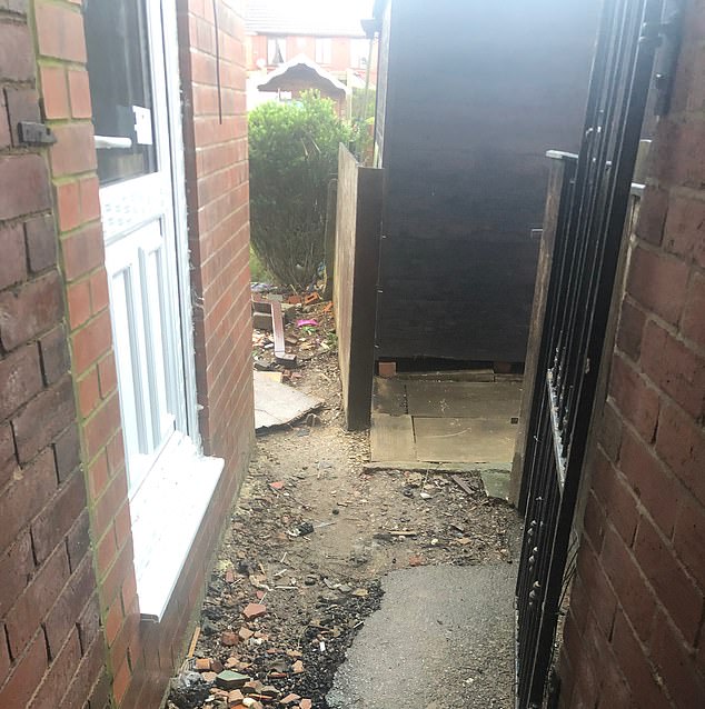 The builders left a massive drop from back door into her back garden due to plans which Ms Barker says were inaccurate