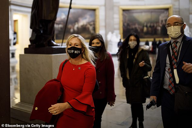 Greene is controversial for her support of the QAnon conspiracy theory that has been debunked. The theories paint President Donald Trump as a secret warrior against a supposed child-trafficking ring run by celebrities and 'deep state' government officials. Greene pictured Sunday at the US Capitol