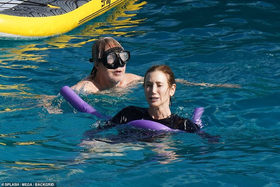 Fun in the sun: The iconic singer went shirtless for much of the day as he went swimming with Nancy
