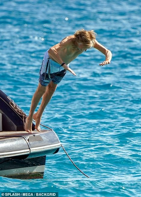 Splash: Paul, who sported blue swimming trunks, dived off the edge of the boat numerous times