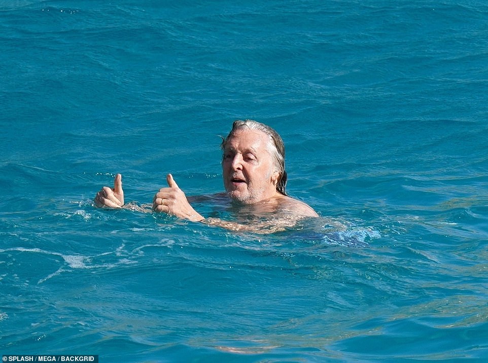 Thumbs up: Paul looked in good spirits as he worked on his fitness by going for a swim