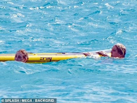 Sun-kissed: The couple looked in good spirits as they laughed and frolicked in the water together while making the most of their holiday