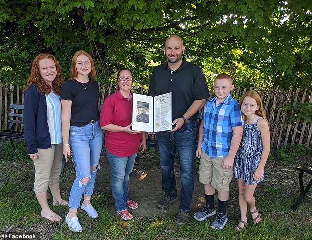 survived by his wife, Angela (left), and their three children, Addison (second left), Claire (right) and Michael (second from right)