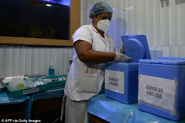 A health official prepares a vaccine kit as she takes part in dry run or a mock drill for Covid-19 coronavirus vaccine delivery at a primary health centre in Chennai