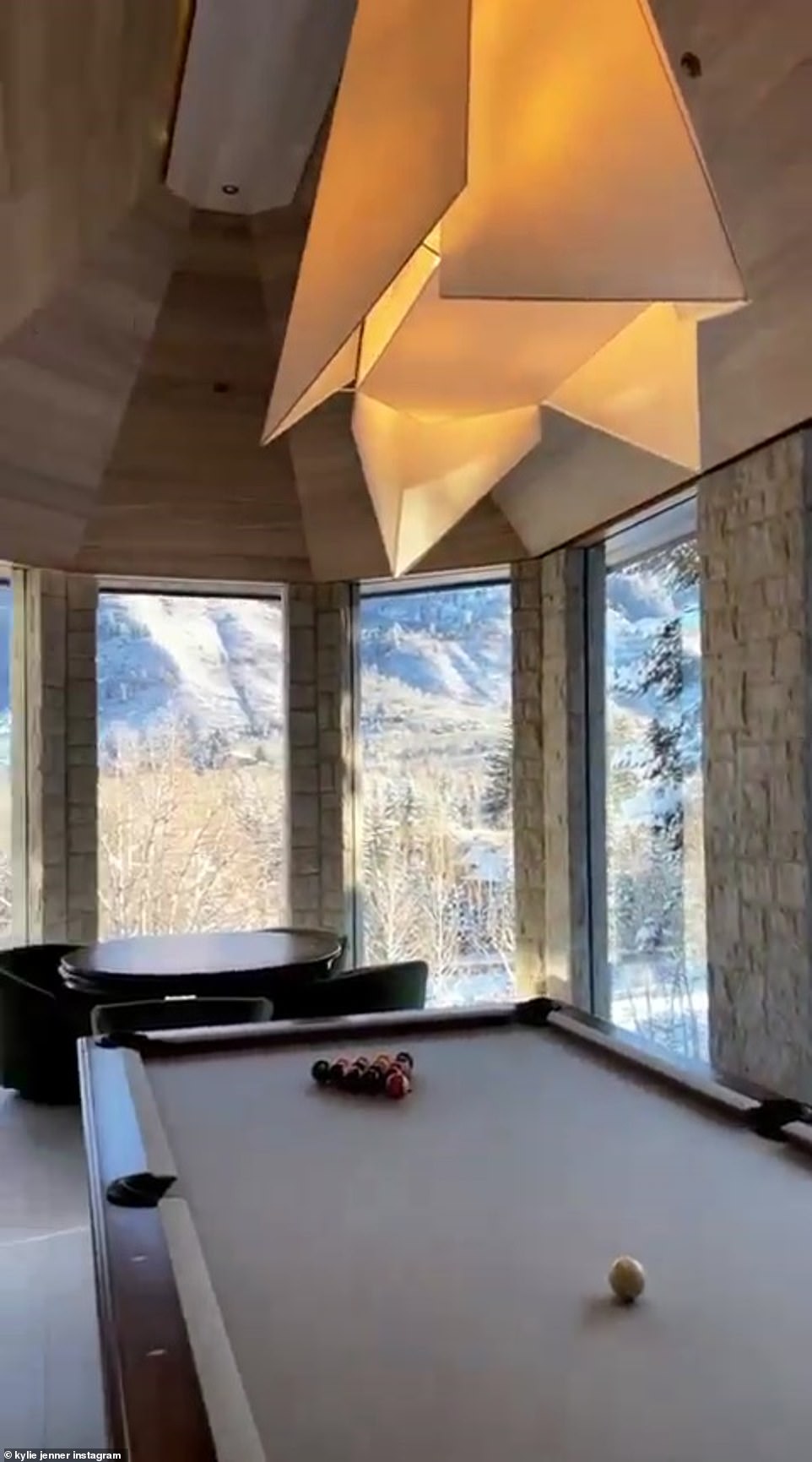 Playing a game: The near-billionaire turned back inside to highlight the home's pool table, which had an impressive view of its own