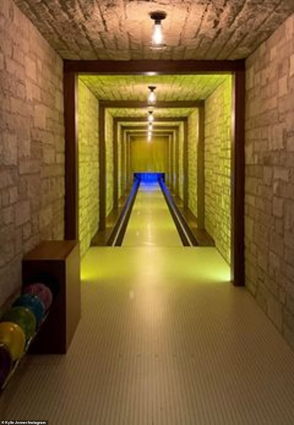 Playing a round: She also showed off the long stone corridor with the bowling alley