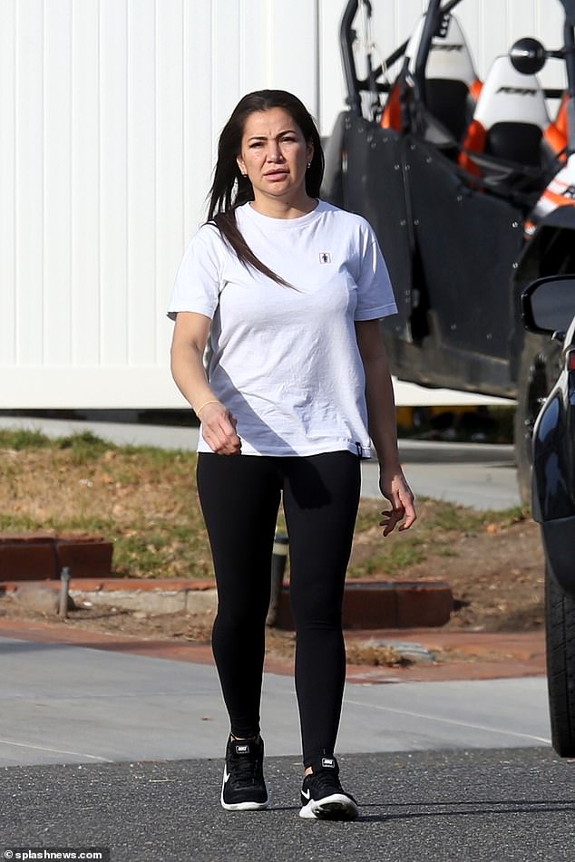 Nicole Ponsetto is seen in black leggings and a white t-shirt as she walks across the parking lot