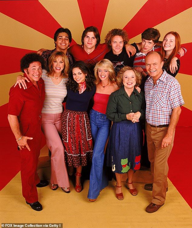 In 1998, Roberts returned to the small screen to play Midge in That 70s Show. She is pictured front row second from left. The show also starred Ashton Kutcher (back row second from left) and Mila Kunis (front row third from left)