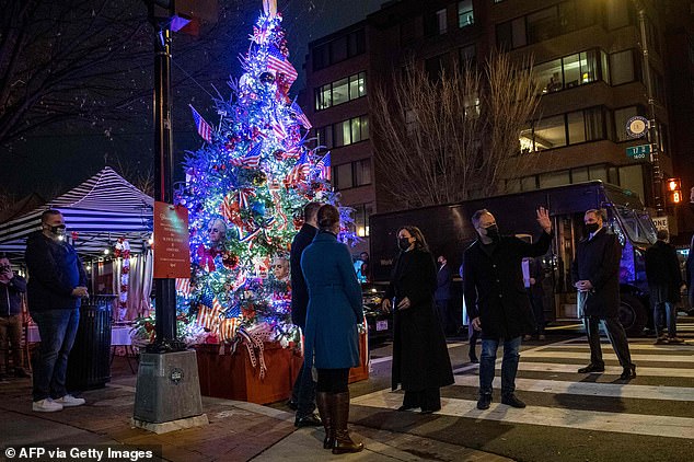 Harris and Emhoff are photographed in front of a Harris and Biden-themed Christmas tree on D.C.'s LGBTQ-friendly 17th Street N.W.