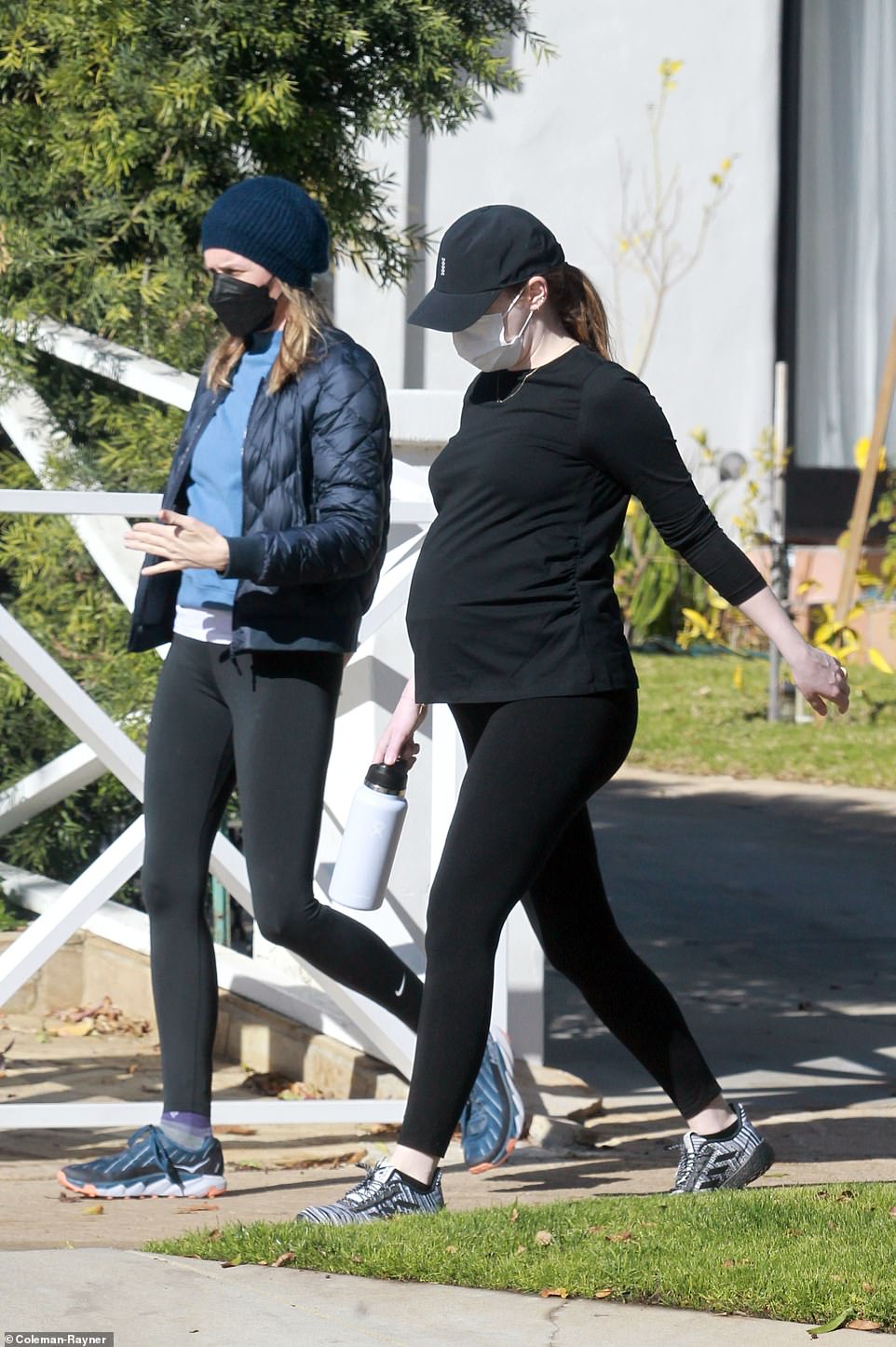 She wore an all black outfit with leggings and a tight flitted shirt that accentuated her belly, with a cap and sneakers