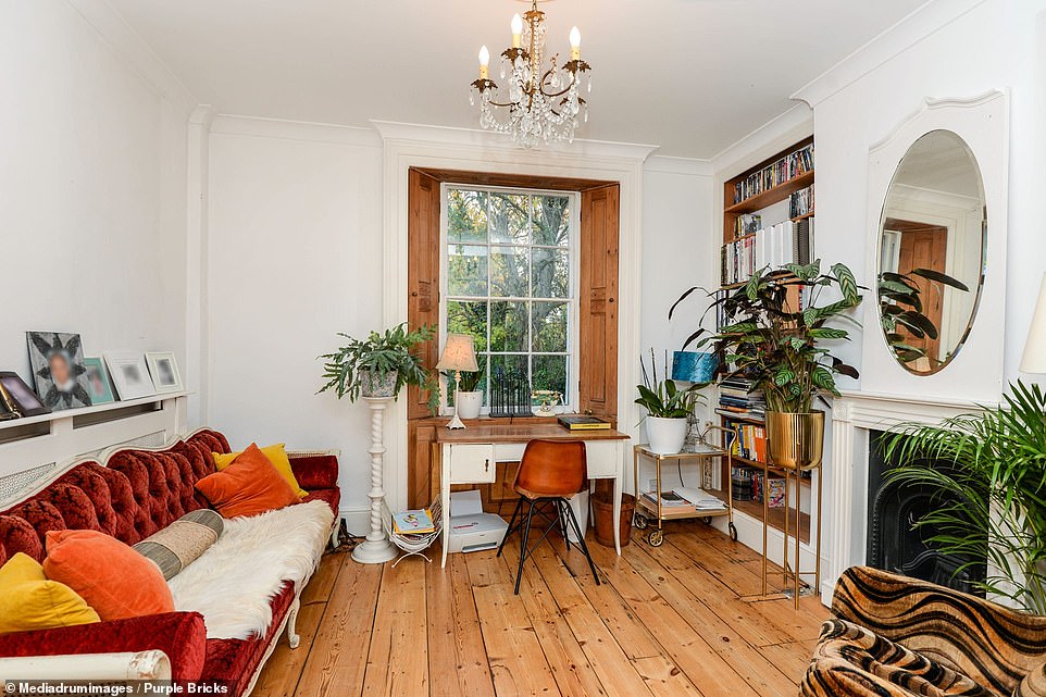 The 1755 sq. ft property has four bedrooms, two bathrooms, a family kitchen/diner and two reception rooms. Pictured one of the home's living room areas with wooden floors