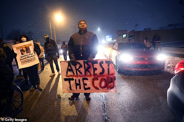 Activists show support for Jacob Blake Jr. during a vigil near the Kenosha County Courthouse on January 4, in Kenosha, Wisconsin