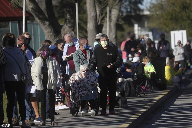 Hundreds of people wait in line Tuesday, December 29, 2020, at the STARS Complex in Fort Myers, Fla., to receive the first dose of a COVID-19 vaccine