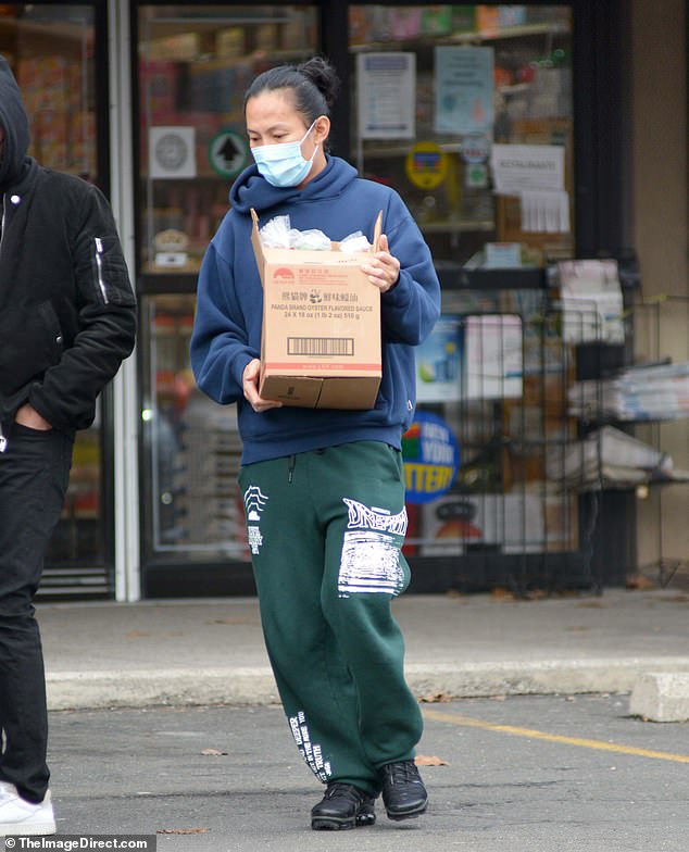 Errands: The 37-year-old disgraced designer was sporting sweats and hauling a cardboard box labeled 'Panda Brand Oyster Flavored Sauce'