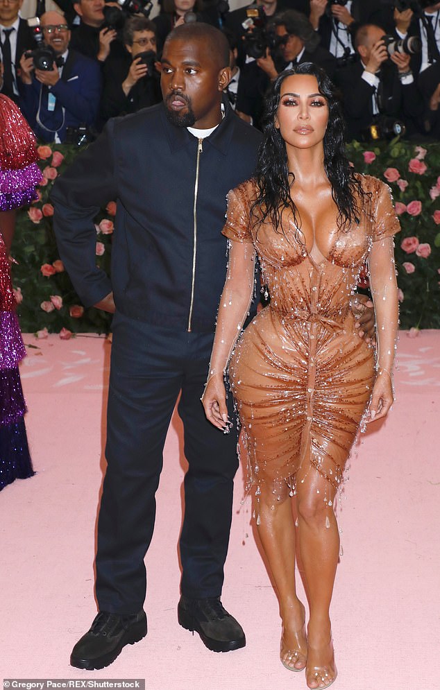 Holding on: Last month it was claimed that Kim and Kanye were still together but 'living separate lives'