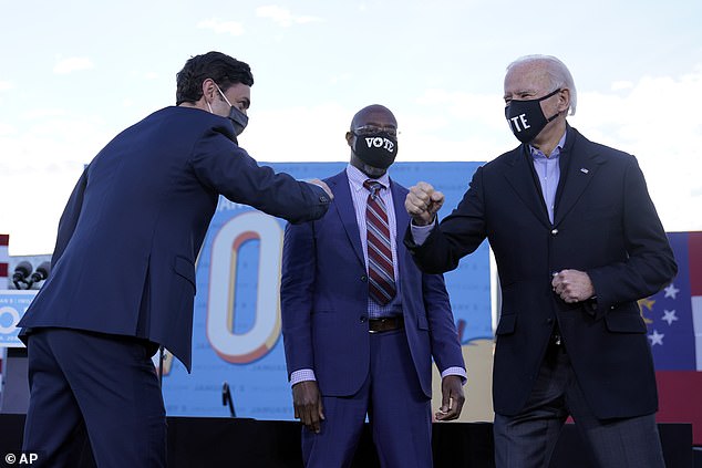 Earlier in the day, President-elect Joe Biden held an event campaigning for Democratic challengers Jon Ossoff (left) and Reverend Raphael Warnock (center)