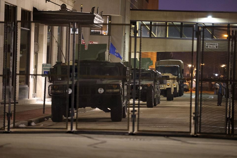 Heavily armored vehicles are stationed near the courthouse Tuesday following the announcement that no charges will be brought against the white cop