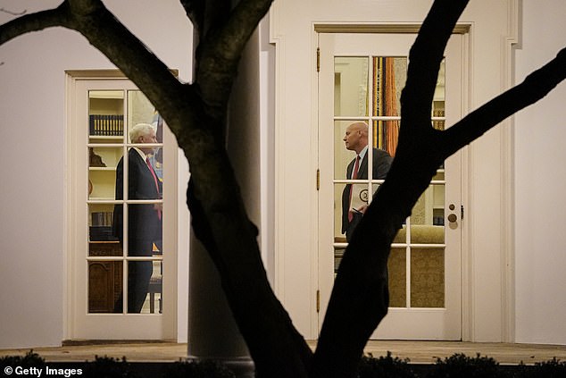 Vice President Mike Pence (left) and his Chief of Staff Marc Short stand in the Oval Office before President Donald Trump departs the White House on Monday for a campaign rally in Georgia