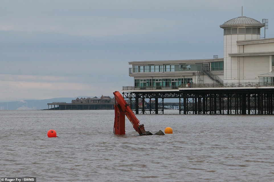 The tipper truck was eventually saved from the incoming tide but despite rescuers' efforts the orange digger was today lost among the waves after the recovery mission had to be abandoned