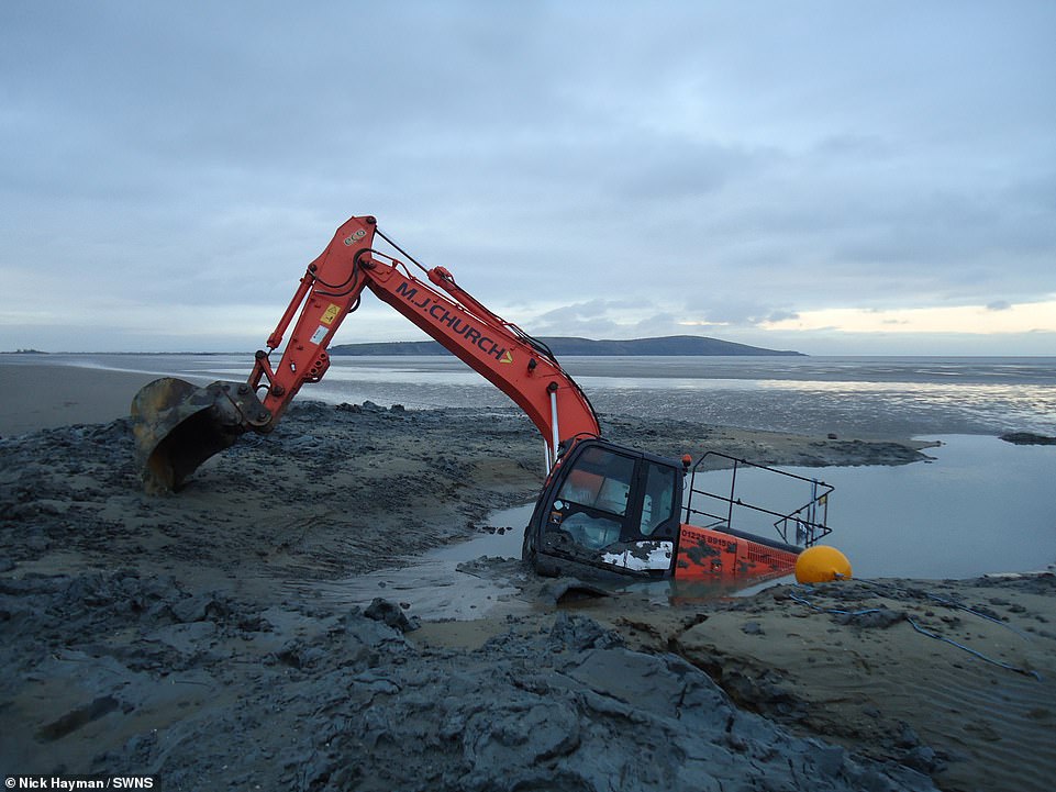 In farcical scenes, a second digger belonging to contractor MJ Church was sent in to try to save the first after it sank on the shoreline at Weston-super-Mare, Somerset, yesterday