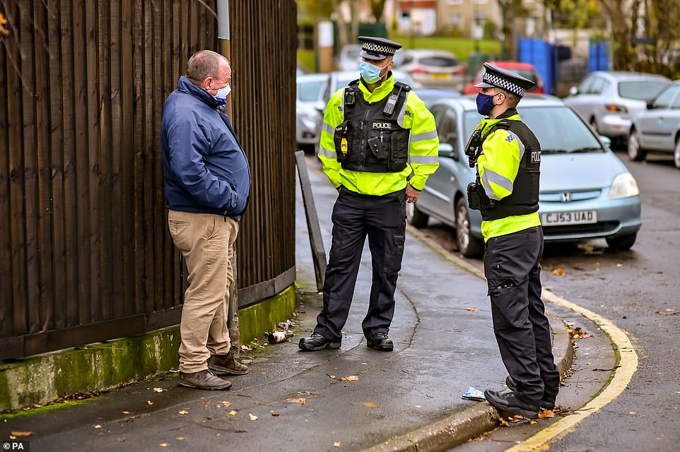 Police officers chat with members of the public on patrol around the Barton Hill area