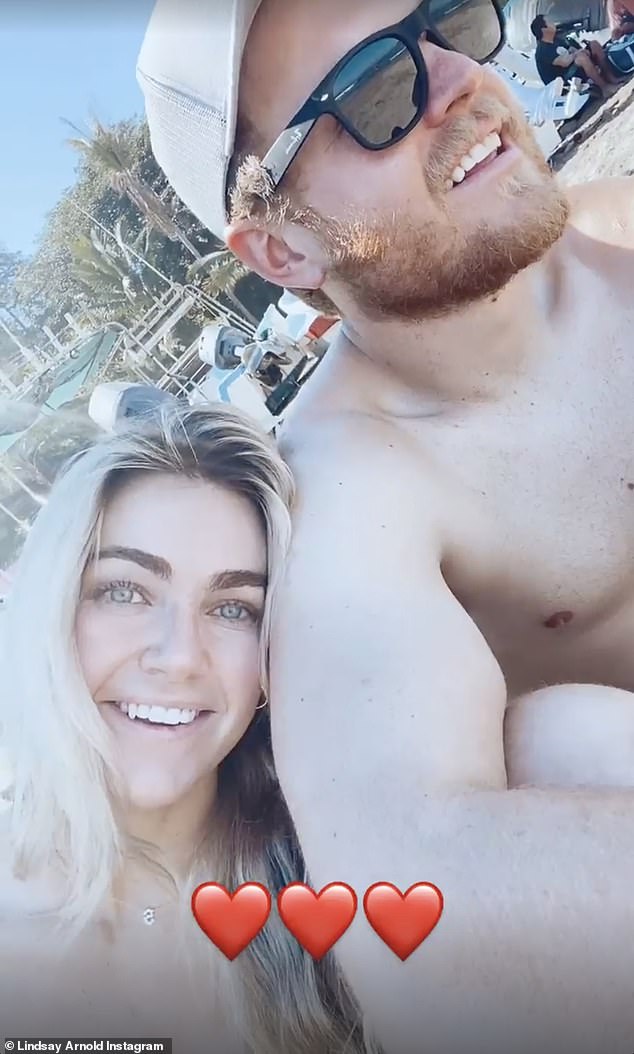 So in love: Here she is seen with her high school sweetheart turned husband on the trip