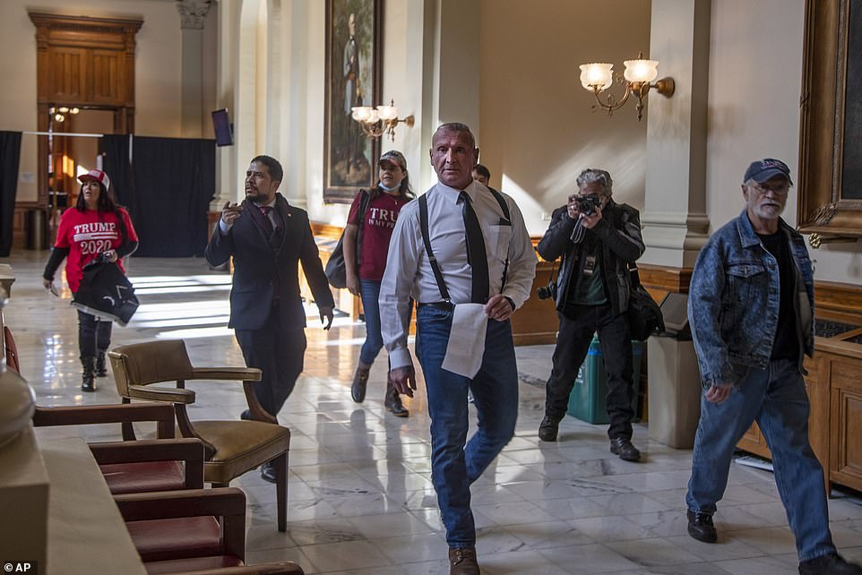 ATLANTA: Ex Klu Klux Klan member Chester Doles, center, leader of American Patriots USA, roams the third floor of the Georgia State Capitol building looking for the office of Georgia Secretary of State Brad Raffensperger
