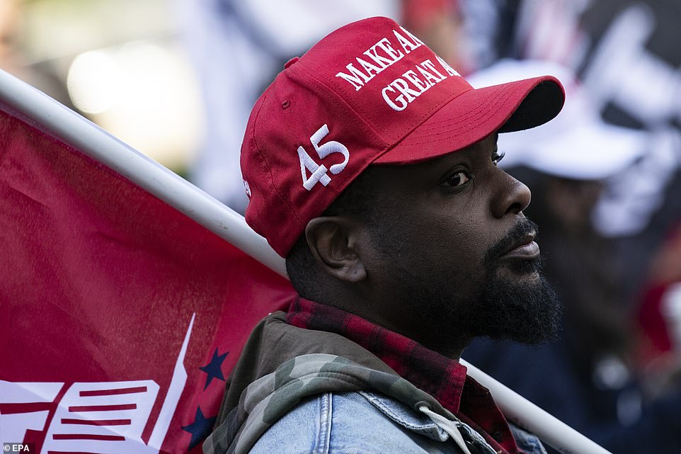 LA: A Trump supporter wears a 'Make America Great Again' cap as Pro-Trump protesters demonstrate