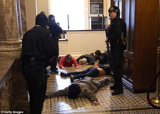 U.S. Capitol Police stand detain protesters outside of the House Chamber during a joint session of Congress on January 06, 2021 in Washington, DC