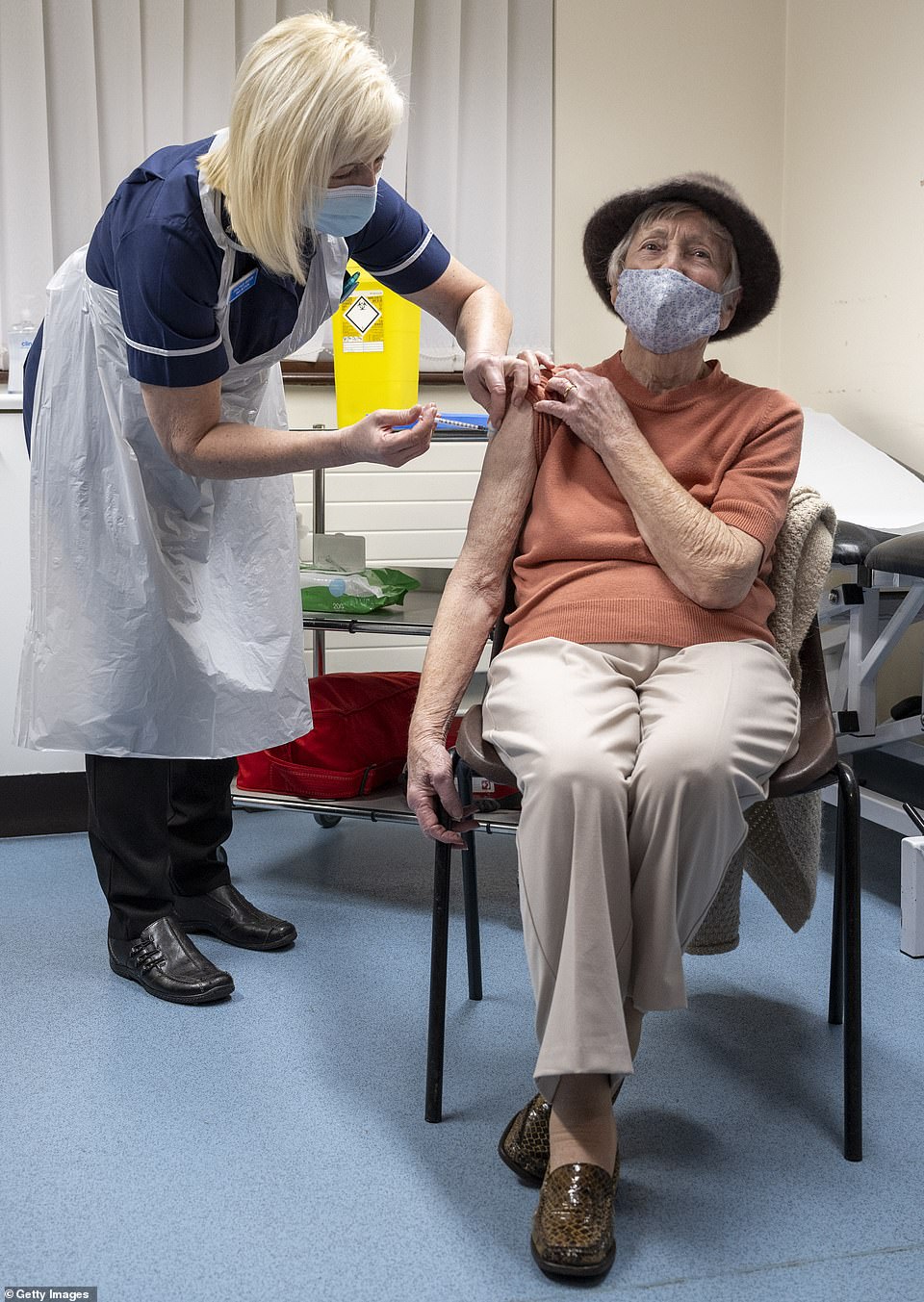 A nurse administers the Oxford-AstraZeneca vaccine to a patient at Pontcae Medical Practice on January 4 in Merthyr Tydfil, Wales. The Oxford-AstraZeneca COVID-19 vaccine was administered at a handful of hospitals before being rolled out to hundreds of GP-led sites across the country