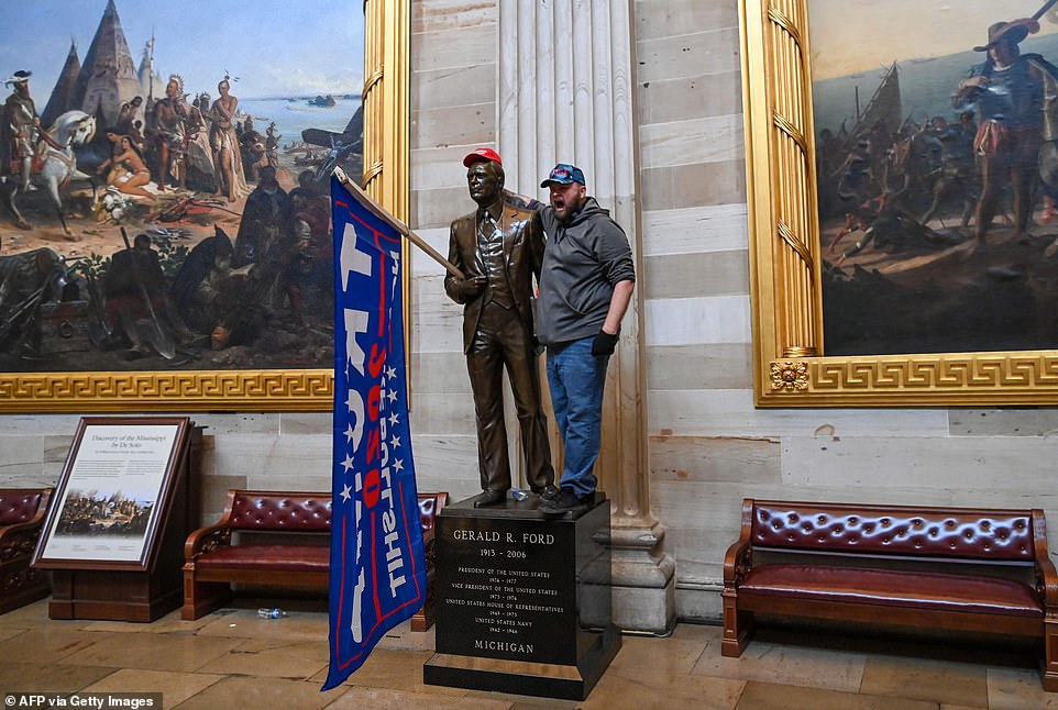 A Trump supporter posed alongside a statue of President Gerald Ford inside the Capitol