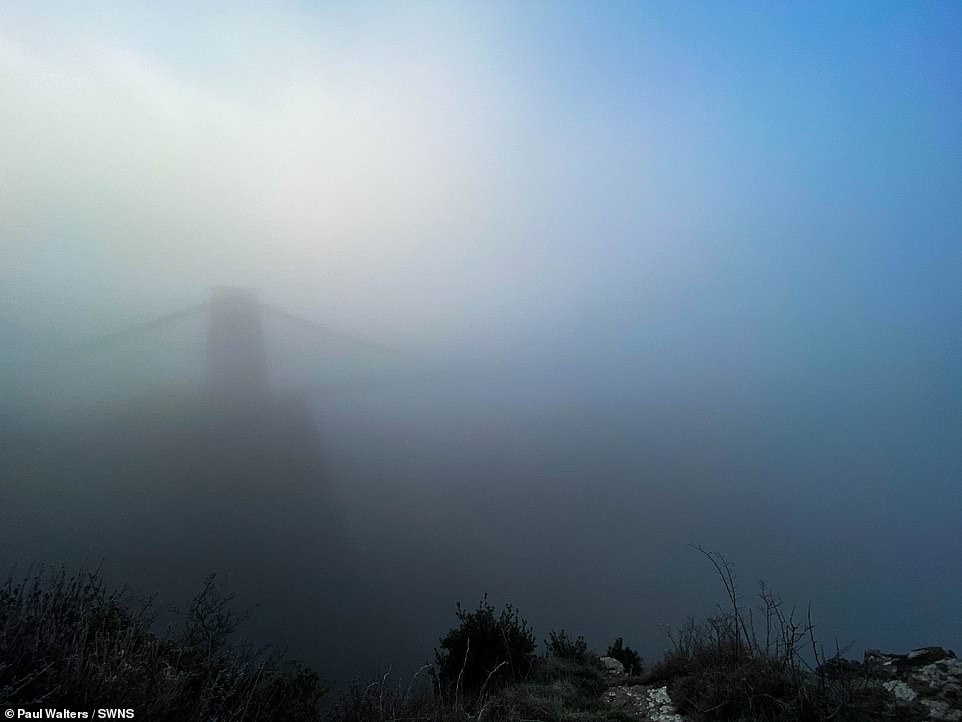 Visibility has been cut over Clifton Suspension Bridge in Bristol this morning as dense fog blankets western parts of England
