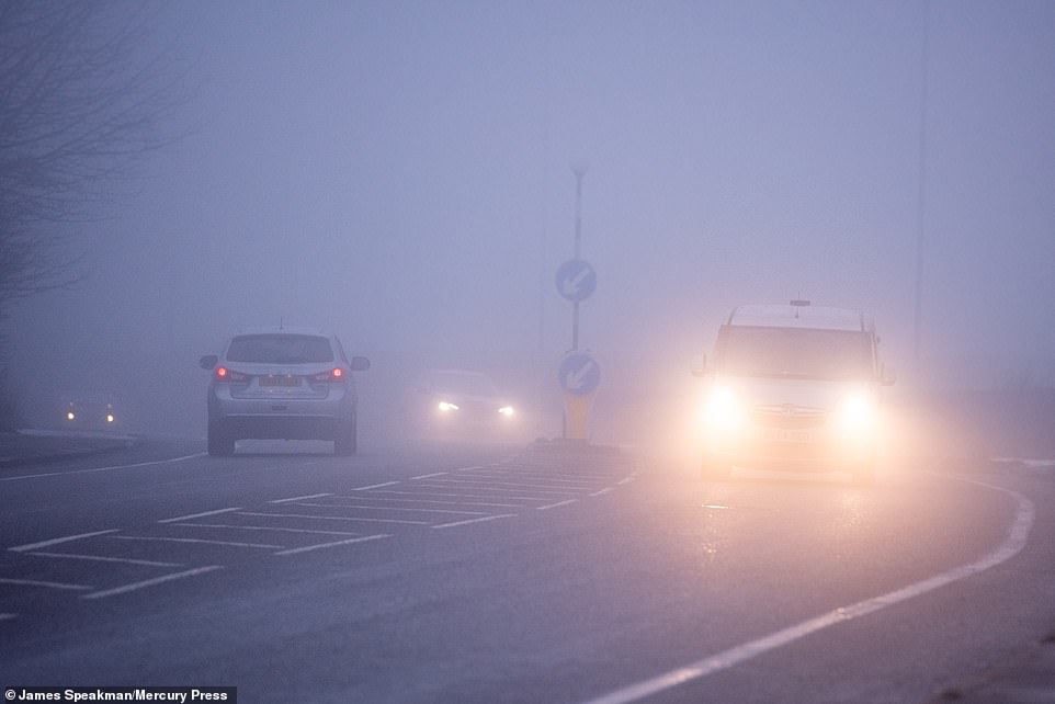 Manchester woke up to temperatures -2C this morning, with fog near Bolton (pictured) as some motorists still braved conditions to go to work during England's third coronavirus lockdown