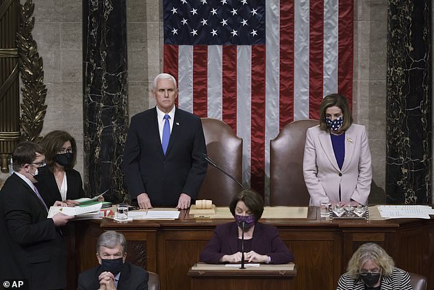 After security forces cleared the US Capitol, Congress reconvened to confirm President-elect Joe Biden as the presidential election winner early on Thursday morning. Vice President Mike Pence (left) and House Speaker Nancy Pelosi (right) read the final certification during a joint session of Congress in the early morning hours of Thursday