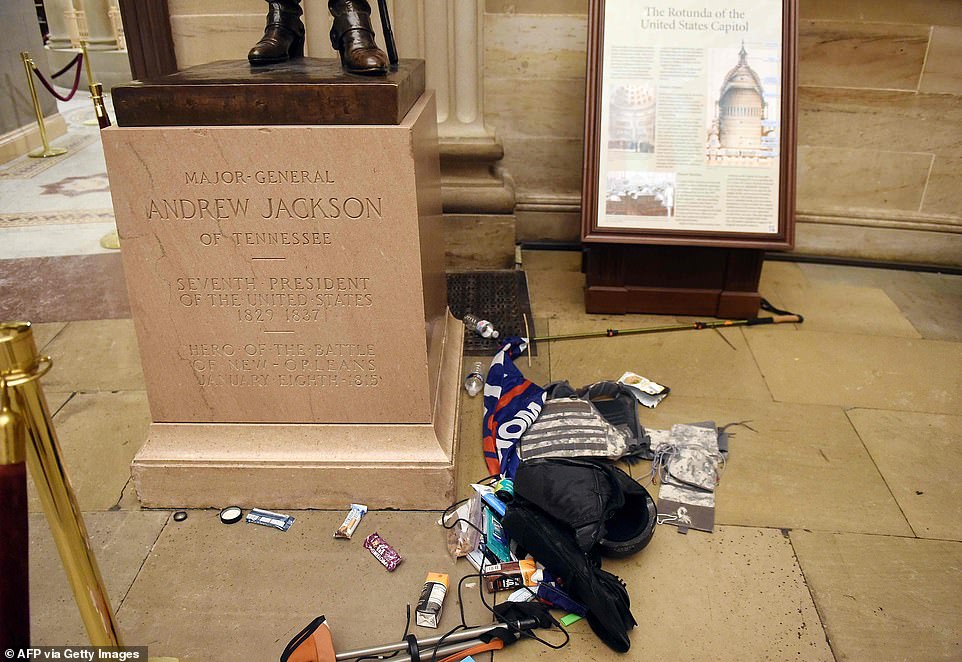 Trash and Trump signs are seen piled beside the statue of the great American hero Major Andrew Jackson