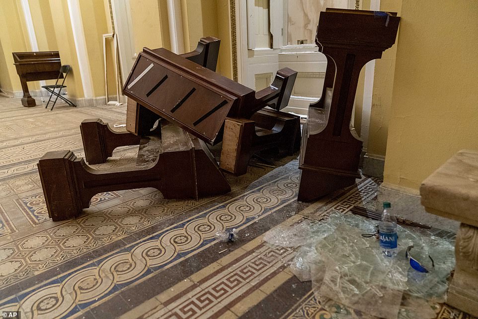 Glass and furniture is piled in the hallways in the early morning hours of Thursday after protesters stormed the Capitol in Washington, on Wednesday