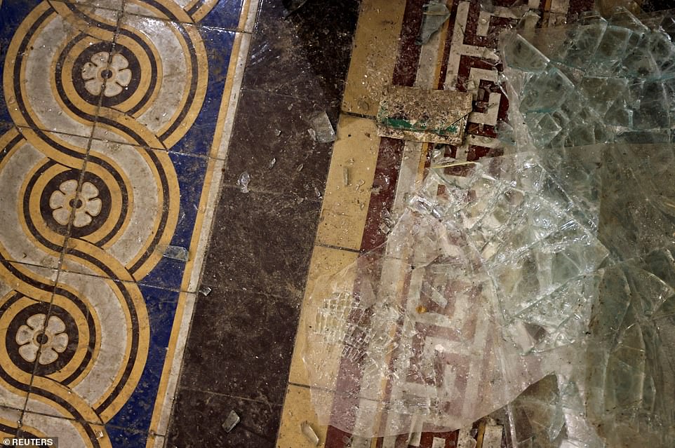 Shards of glass and cracked paving stones are seen in the hallways of the Capitol Building today