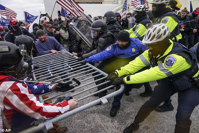 Trump supporters try to break through a police barrier set up around the U.S. Capitol Building to protect lawmakers as they certify the Electoral College results