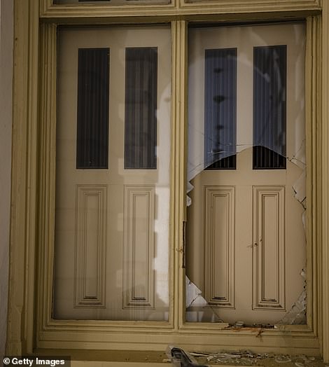 A window is seen shattered next to the Senate Carriage Entrance on the eastern side of the U.S. Capitol